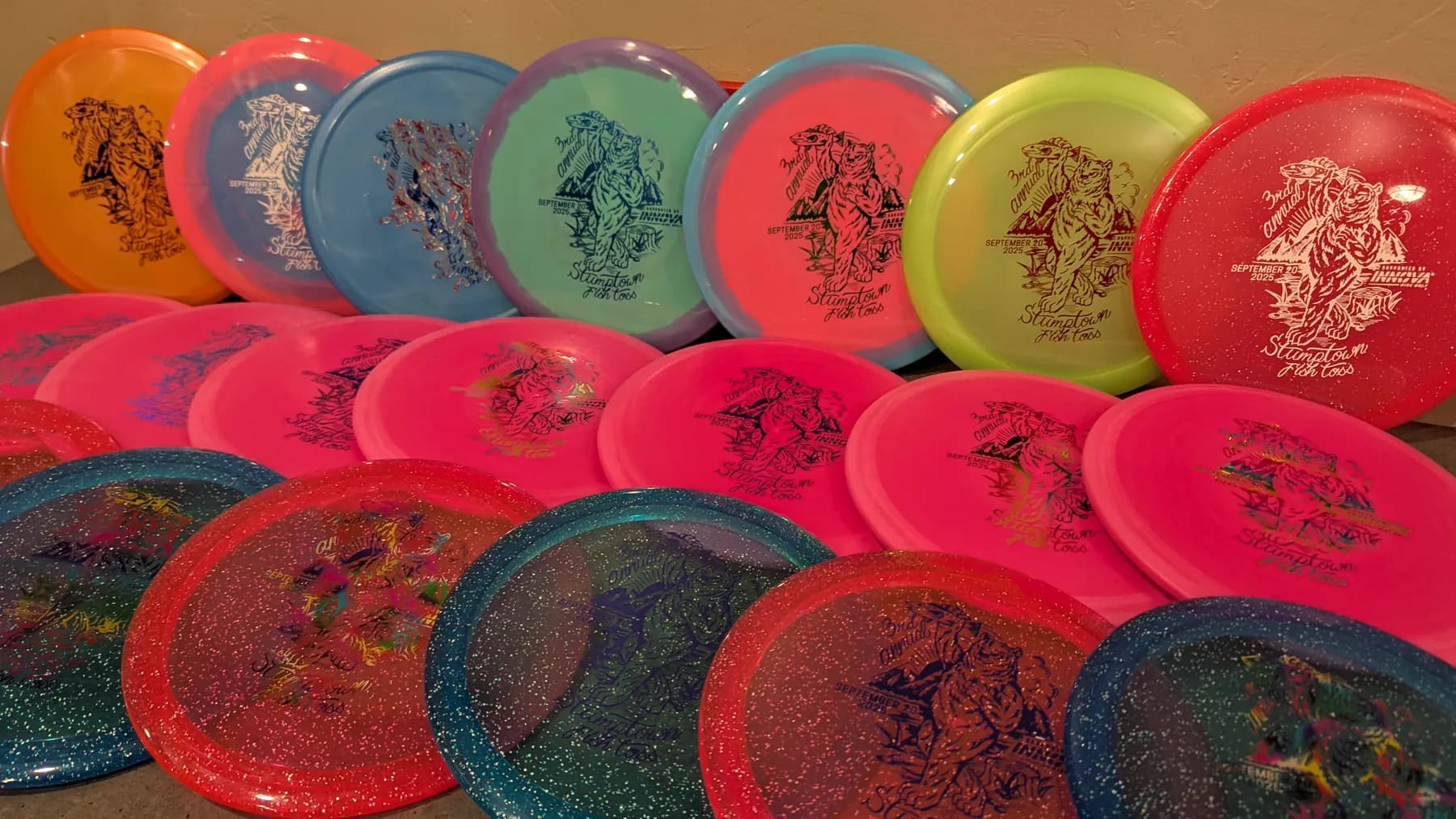 Rows of colorful stamped discs for the third annual event lean upright in a display.