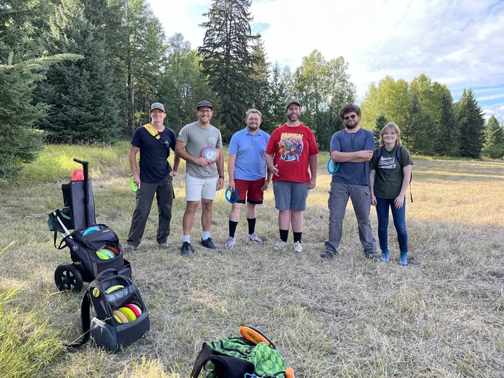 A group out on the course with a cart