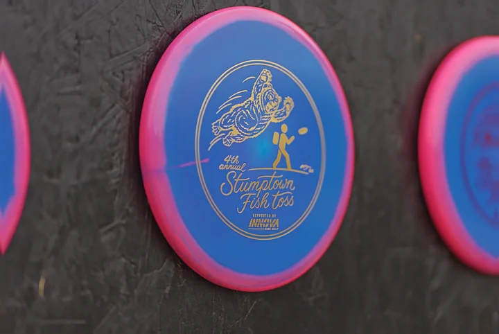 A 2026 Fish Toss disc on the wall