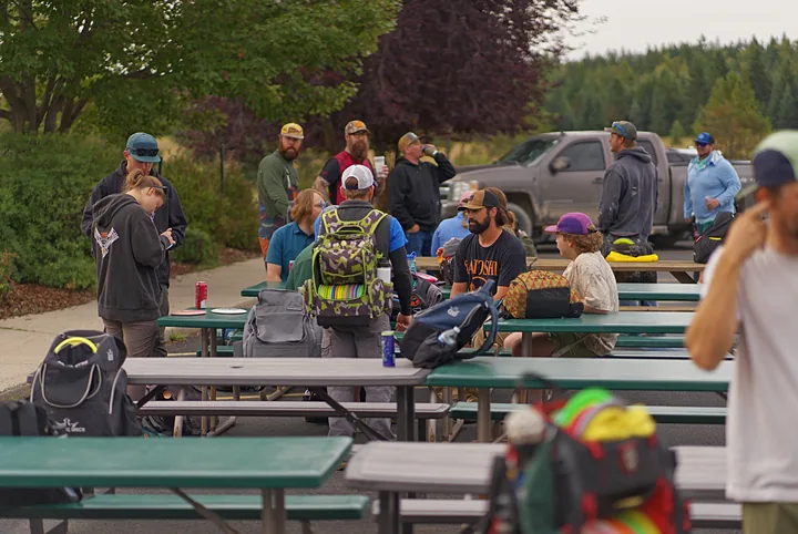 Players gathering at the picnic tables