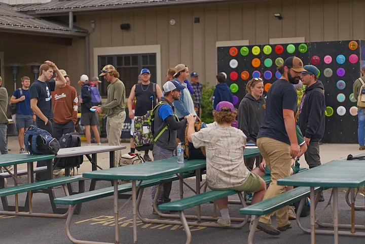 Players gathering at the picnic tables
