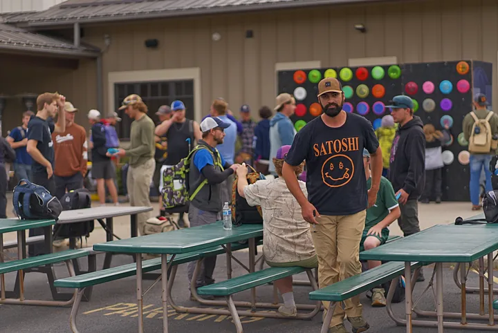Players gathering at the picnic tables