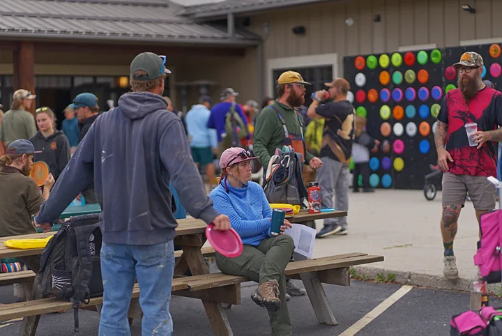 Players gathering at the picnic tables