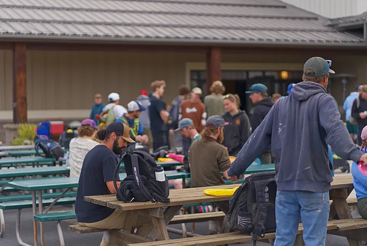 Players gathering at the picnic tables