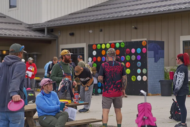 Players gathering at the picnic tables