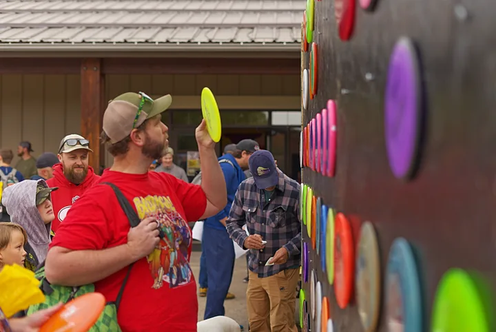 A player holding up the disc he picked from the wall
