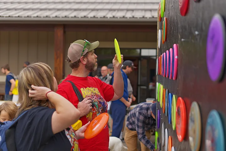 A player holding up the disc he picked from the wall